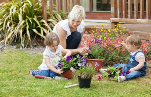 Worker preparing garden site for fence installation